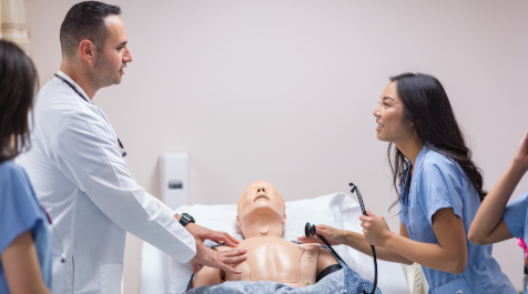 Student and teacher practicing on manikin
