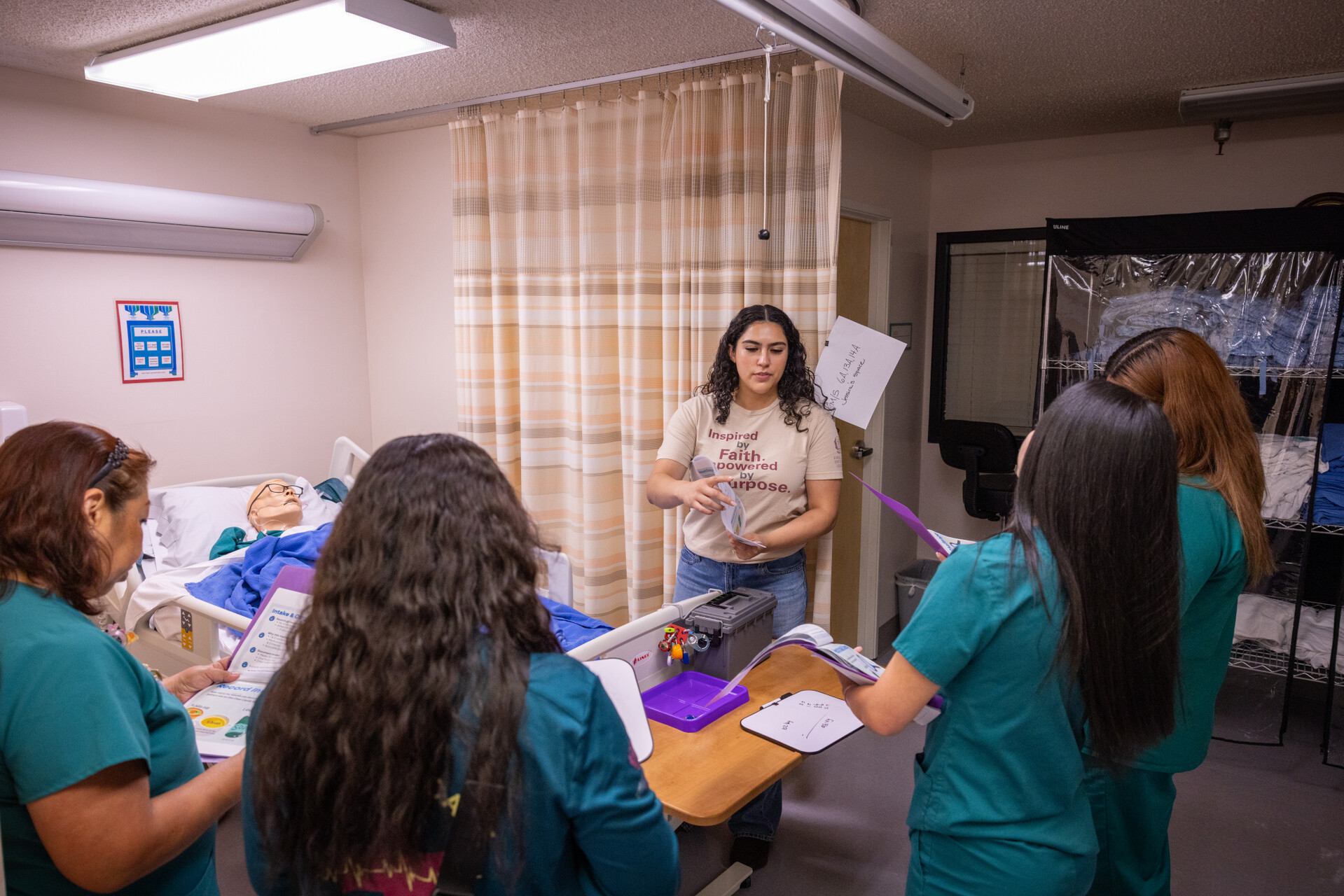 A nursing leader trains a team of nurses in a simulation environment.