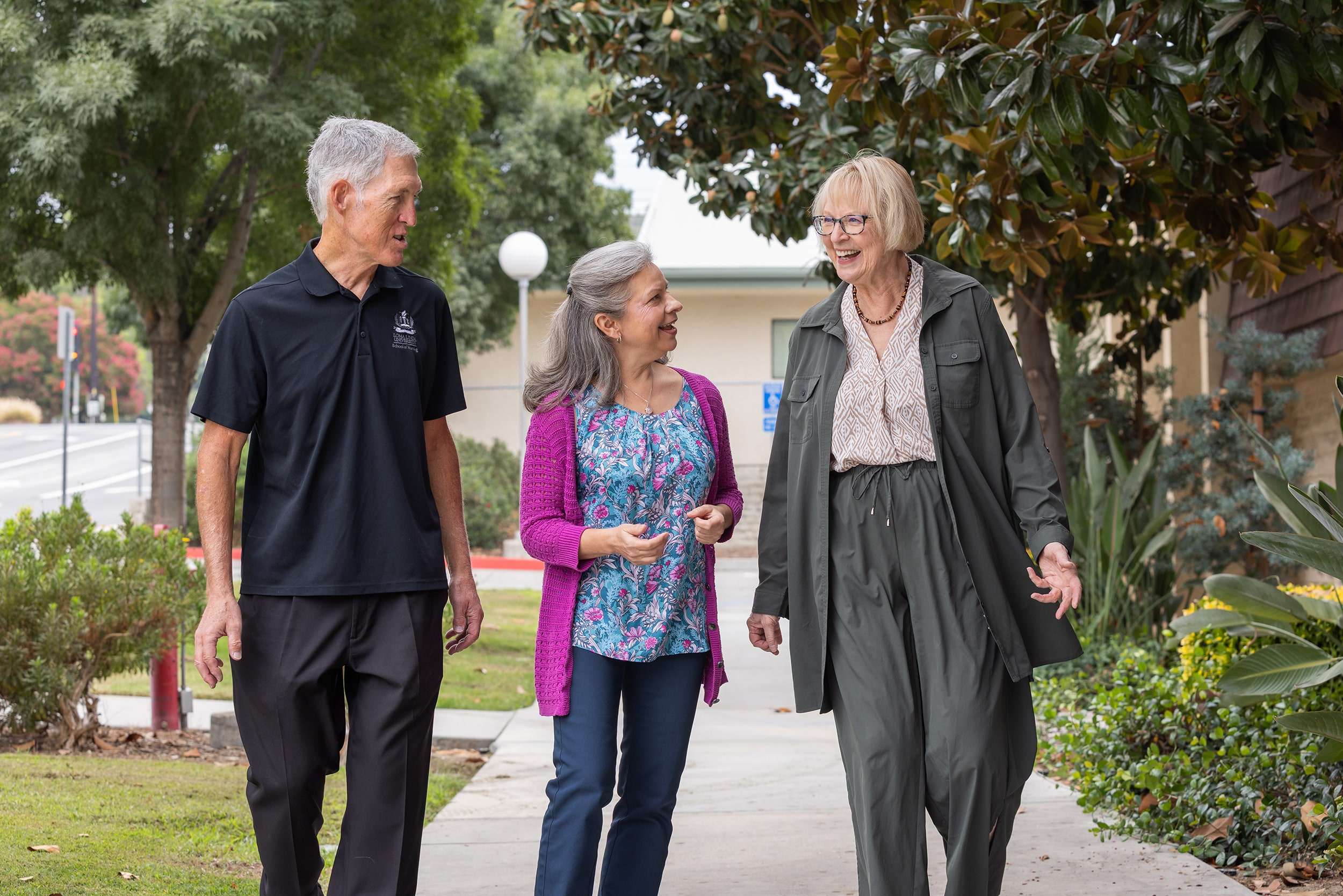 Jan Michaelis, Lisa Roberts, and Ellen D’Errico walking around campus.
