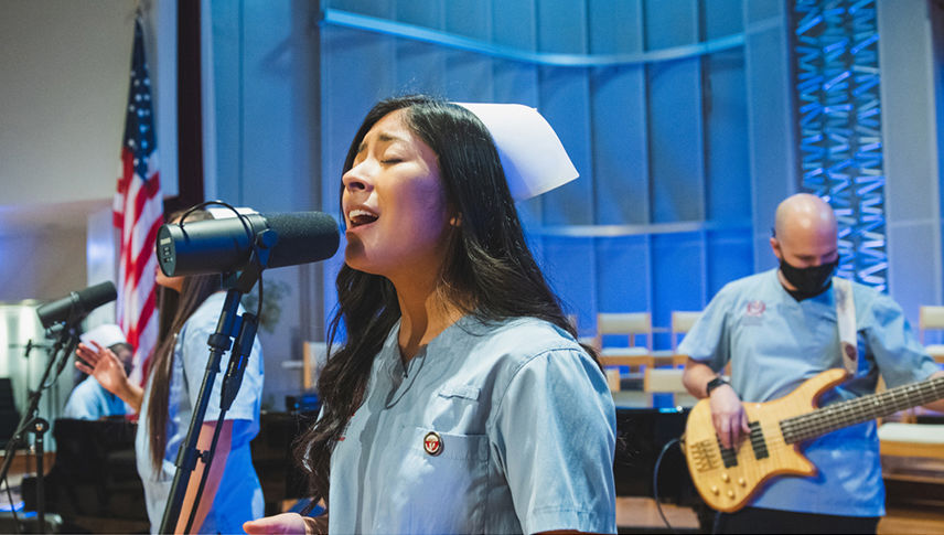 nursing students singing on stage at dedication 2021