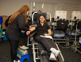 A blood donor participates in the Nursing Hearts blood drive.