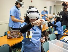 Nursing student utilizating a virtual reality headset.