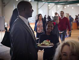 Man with food plate in hand smiling